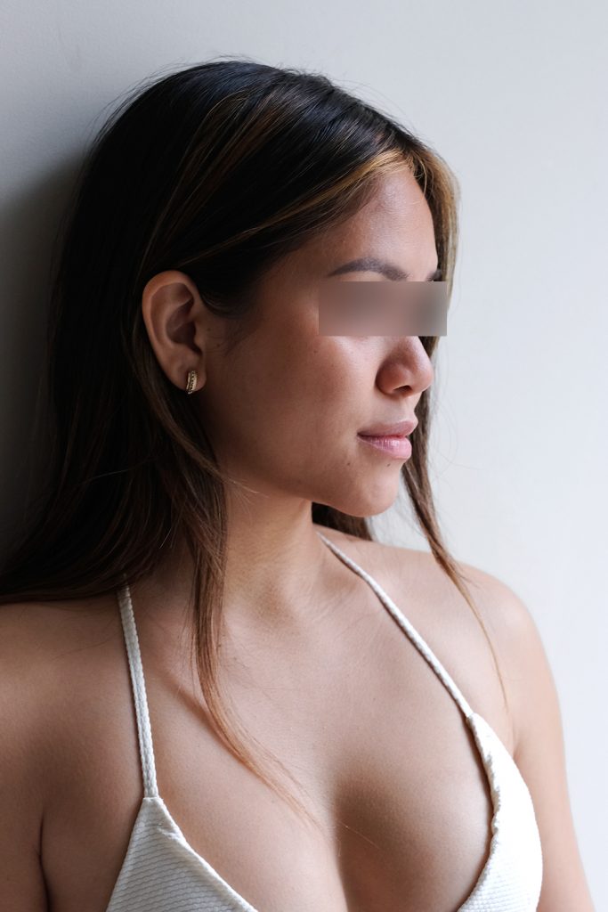 Escort Girl Lena trägt ein weißes Bikini Oberteil